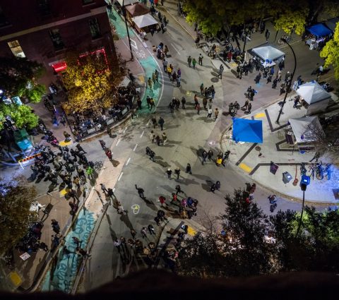 Crowds of people seen from above on the streets of Winnipeg's Exchange District for Nuit Blanche.