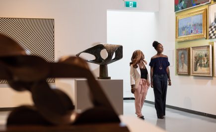 Two women enjoying an exhibit at the Winnipeg Art Gallery.